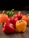 Peppers of differents colors. Vegetables on wooden table