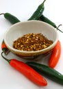 Peppers, fresh and dried flake in bowl Royalty Free Stock Photo