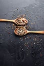 Peppers mix, sea salt, cardamon, mustard seeds and paprika flakes in wooden spoons. Royalty Free Stock Photo