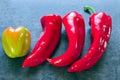 Peppers - three identical and one different in color and shape Royalty Free Stock Photo