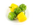 Peppers on white plate isolated close up Royalty Free Stock Photo