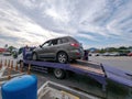 Broken car on the truck with passenger to the workshop