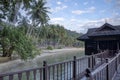 Daytime scene of the unique architectural wooden houses or villas on stilts by the seaside