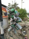 Perak, Malaysia. July 29,2020: A bundle of used and empty aluminium cans tied on the pole as an advertisement by the roadside at K