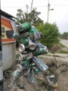 Perak, Malaysia. July 29,2020: A bundle of used and empty aluminium cans tied on the pole as an advertisement by the roadside at K