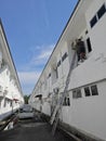 Worker climbed high up to the second storey building servicing the outlet air condition unit