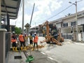 Outdoor scene of workers digging and piling concrete pole preparation for 5G cable connection