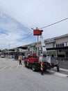 Outdoor scene of workers change streetlight bulb pole with the Rear-mount Ladder truck Royalty Free Stock Photo