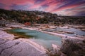 Peranales River that sometimes flows underground near LBJ Ranch in Teaas under crazy sunset sky with fall foliage and tourists Royalty Free Stock Photo