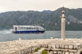 Modern tourist ship sails near the island of Gospa od Skrpjela Our Lady of the Rocks in Boka Kotorska bay