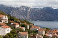 Roofs of old houses in Perast and Bay with mountains in Montenegro