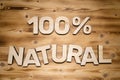 100 percent NATURAL words made of wooden block letters on wooden board Royalty Free Stock Photo