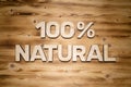 100 percent NATURAL words made of wooden block letters on wooden board Royalty Free Stock Photo