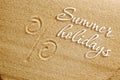 The percent sign is drawn in the sand. Beach background. Top view. The concept of summer, summer kanikkuly, vacation, holydays