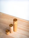 Percentage icon and upward arrows on round wooden sticks as business graph steps on wood desk. Royalty Free Stock Photo