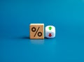 Percentage icon on wooden cube block and up and down arrow symbol on flipping white dice on blue background. Royalty Free Stock Photo