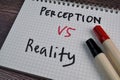 Perception or Reality write on a book isolated on the table Royalty Free Stock Photo