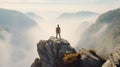 Back of man standing on rock with misty mountain backdrop