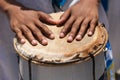 Percussionist's hands resting on top of the atabaque