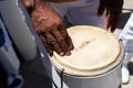 Percussionist's hands resting on top of the atabaque