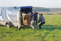 People take out a basket of an air balloon from a covered trailer for a flight at the festival of aeronautics