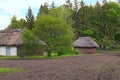 Classic landscape view of Ukrainian small ancient clay house with a garden surrounded by a wicker Royalty Free Stock Photo