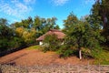 Reconstruction of an ancient clay house with thatched roof and back yard Royalty Free Stock Photo