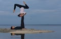 Perfect acroyoga. Beautiful young couple is balancing