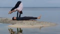 Perfect acroyoga. Beautiful young couple is doing yoga