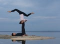 Perfect acroyoga. Beautiful young couple is doing yoga