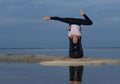 Perfect acroyoga. Beautiful young couple is doing yoga