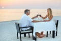 The perfect anniversary. a mature couple enjoying a romantic dinner on the beach. Royalty Free Stock Photo