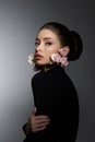 Perfect art woman in black turtleneck on a dark background. Brunette long hair is pulled into a bun. Evening makeup Royalty Free Stock Photo