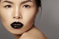 Close-up portrait asian model with fashion lips make-up, clean skin. Beauty halloween style with black lipstick makeup