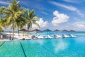 Perfect beach scenery with coconut palm tree around swimming pool in hotel and resort at sunny weather Royalty Free Stock Photo