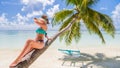 Happy beautiful carefree woman enjoying sunshine on the beach. Young woman in red pink bikini in white sandy beach at Maldive Royalty Free Stock Photo