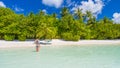 Happy beautiful carefree woman enjoying sunshine on the beach. Young woman in red pink bikini in white sandy beach at Maldive Royalty Free Stock Photo