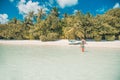 Happy beautiful carefree woman enjoying sunshine on the beach. Young woman in red pink bikini in white sandy beach at Maldive Royalty Free Stock Photo