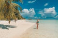 Happy beautiful carefree woman enjoying sunshine on the beach. Young woman in red pink bikini in white sandy beach at Maldive Royalty Free Stock Photo