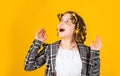 Perfect beauty. Girl with curlers and hair clips in her hair on yellow background. Little girl curlers around her hair