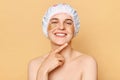 Perfect beauty regimen. Cosmetology expertise. Beauty patch application. Charming joyful woman wearing shower cap with eye patches