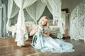 Perfect Blonde Woman Sitting on Wooden Floor