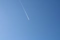 A perfect blue sky and an airplane with its path Royalty Free Stock Photo