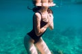 Perfect body of sporty woman in sea, underwater in blue ocean