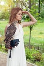 Perfect bride woman in white dress holding bird outdoor Royalty Free Stock Photo