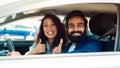 Perfect car. Happy middle eastern spouses showing thumbs up gesture, sitting in new auto, looking out of window Royalty Free Stock Photo