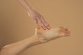 Perfect clean female feet . Beautiful and elegant groomed woman`s hand touching her foot . Spa ,scrub and foot care