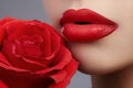 Perfect clean skin, red lip make-up. Beautiful visage portrait with red rose flower Royalty Free Stock Photo