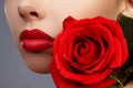 Perfect clean skin, red lip make-up. Beautiful visage portrait with red rose flower Royalty Free Stock Photo