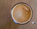 A top down view of an inviting glass mug of fresh coffee on a table Royalty Free Stock Photo